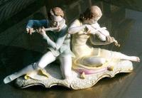 Large porcelain figural of boy playing flute and girl Hutschernreuther