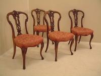 Four Victorian carved walnut upholstered chairs c1860