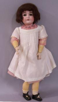 Antique German porcelain bisque doll with cloths c1880