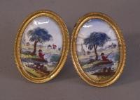 Pair of early porcelain oval brass mirror tiebacks