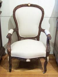 Carved black forest upholstered bark chair with boars heads c1880