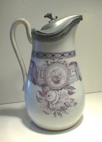 Antique porcelain syrup jug with pewter top