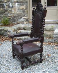 Carved oak chair w  twist turned arms dogs heads leather seat