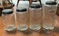 Set of antique kitchen canisters with tin tops