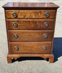 Diminutive tiger maple four drawer chest