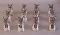 Set of twelve silver plated fox head stirrup cups
