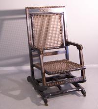 Hunzinger ebonized platform rocker with rare fabric over brass c1870