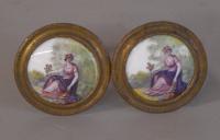 Pair of round porcelain tiebacks depicting a seated woman c1800