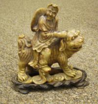 Chinese soapstone man on foo lion