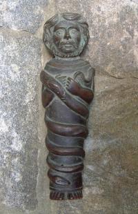 Primitive bronze figure with snake