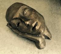 Modern bronze sculpture of a woman at rest